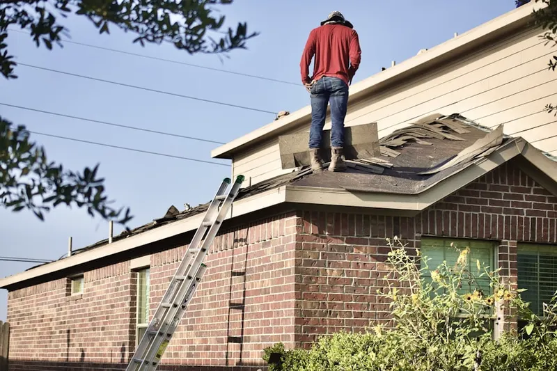 Professional roofer working on a residential roof in Fuller Park